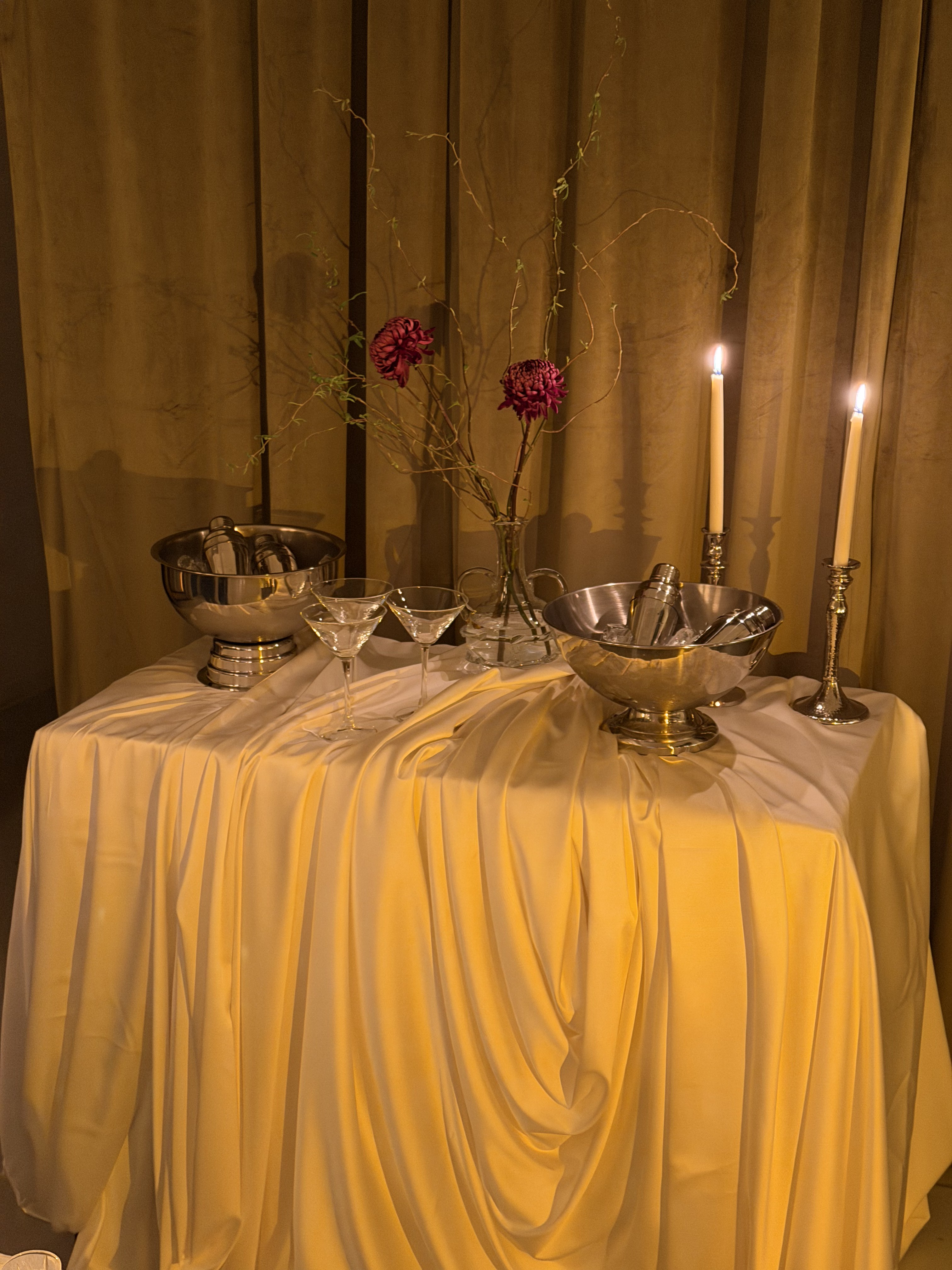Cocktail bar setup with candles and flowers